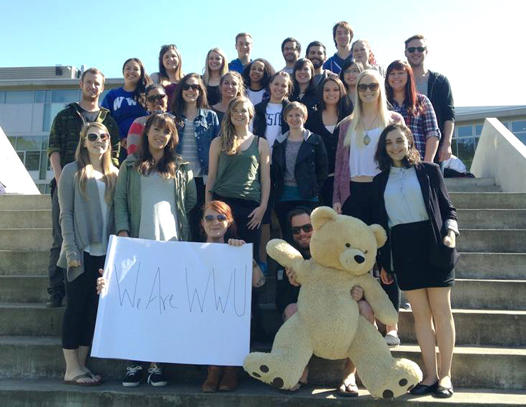 A group of students with Professor Davidson, one student holding a giant stuffed bear.