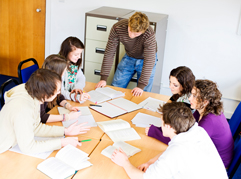 Students working together in a group around a table