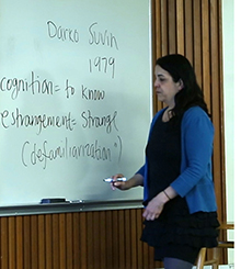 Professor Rivera writing on a whiteboard in front of her class