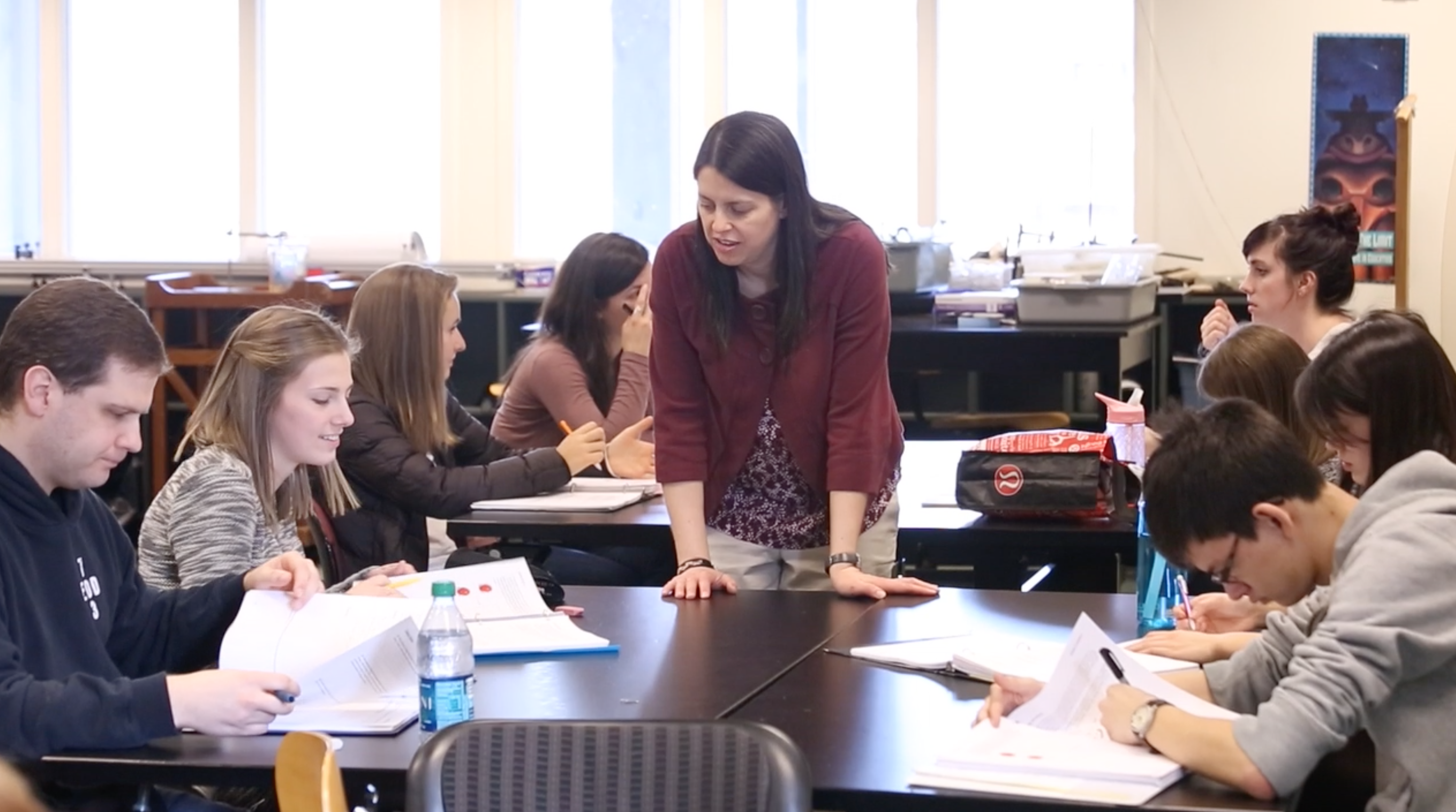 Dr. Borda at a table having a discussion with a group of students
