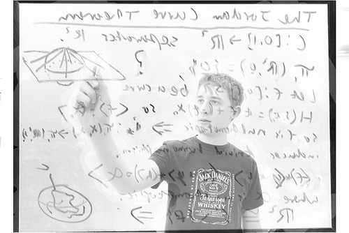 An image of a whiteboard with mathematical equations, overlayed by a semi-transparent man drawing a shape