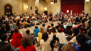 group of people sitting in a circle on the floor