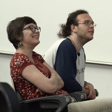 Two students gazing up smiling