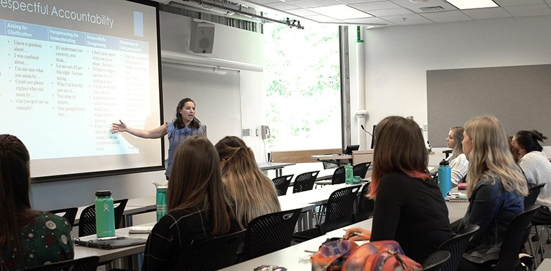 Ferreras Stone lecturing in front of a classroom