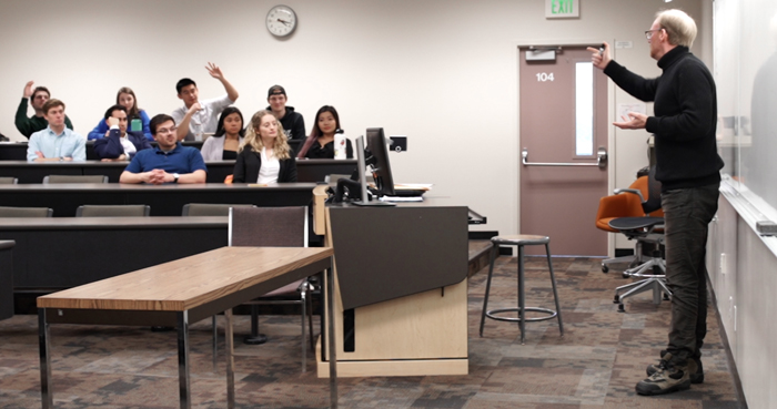 Staton teaching at the front of a classroom