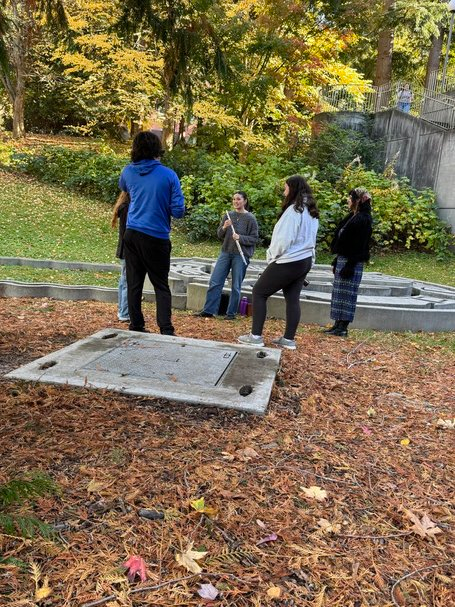 Students working together outdoors on a hands-on learning activity in a fall setting