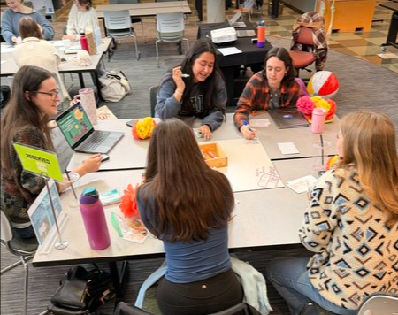 Students collaborating around a table during a group learning activity
