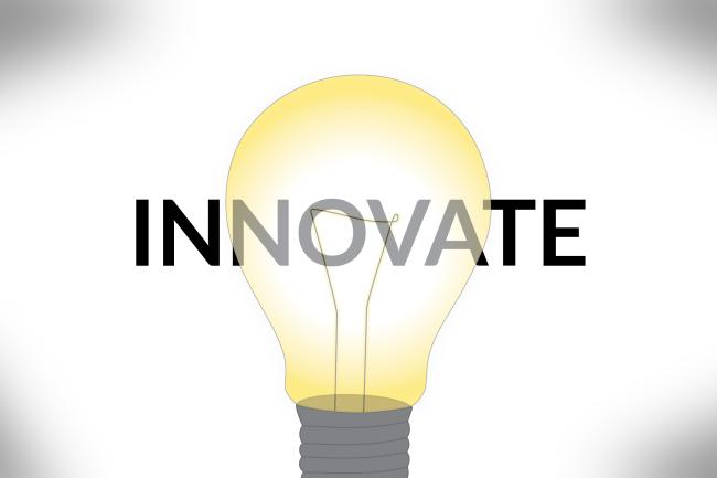 Innovate your teaching. A lightbulb burns white at the center, with yellow around the edges.